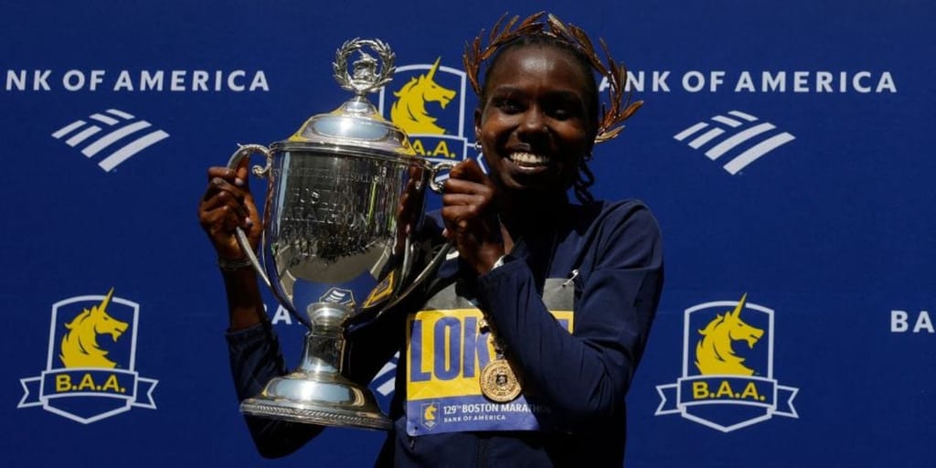 Kenya's Sharon Lokedi celebrates on the podium with the trophy after winning the women's elite race at the 129th Boston Marathon on April 21, 2025.Photo credit: Reuters