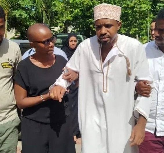 Boniface Mwangi being helped by his wife to walk.