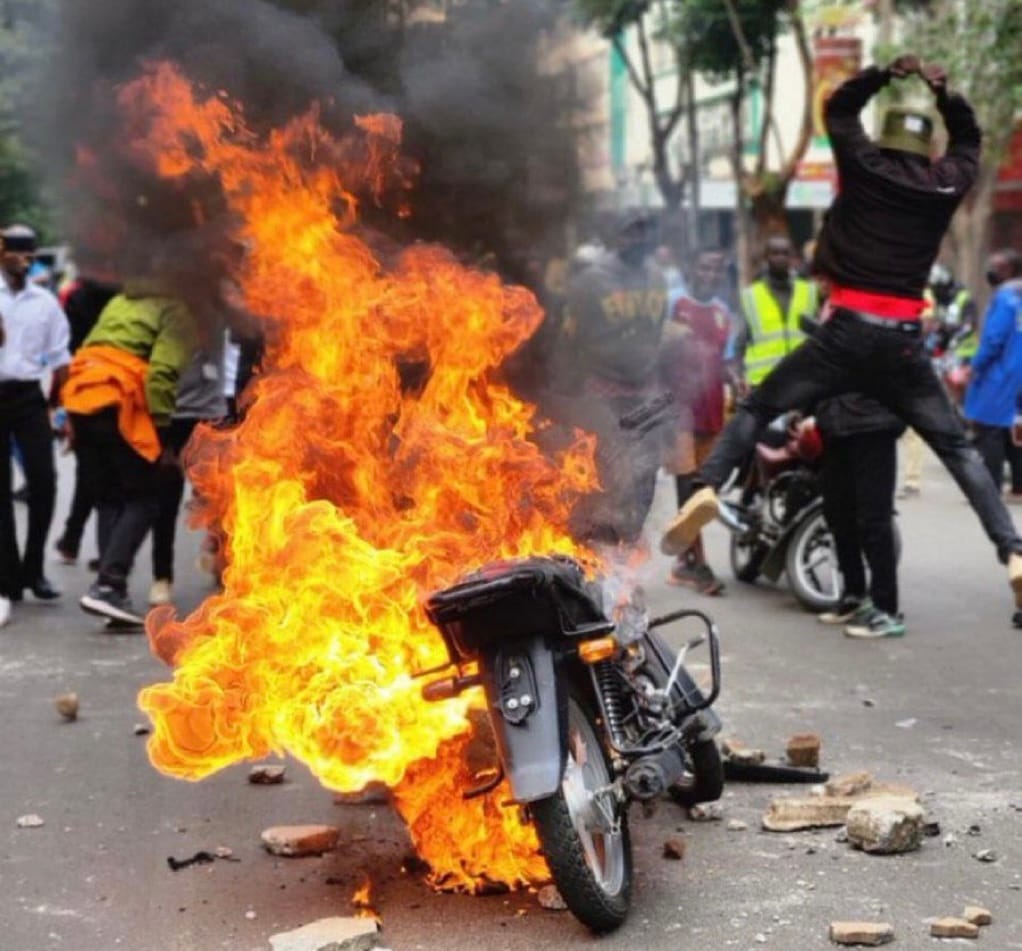 Protestors set a blaze a motorcycle allegedly belong to one of the hired goons.