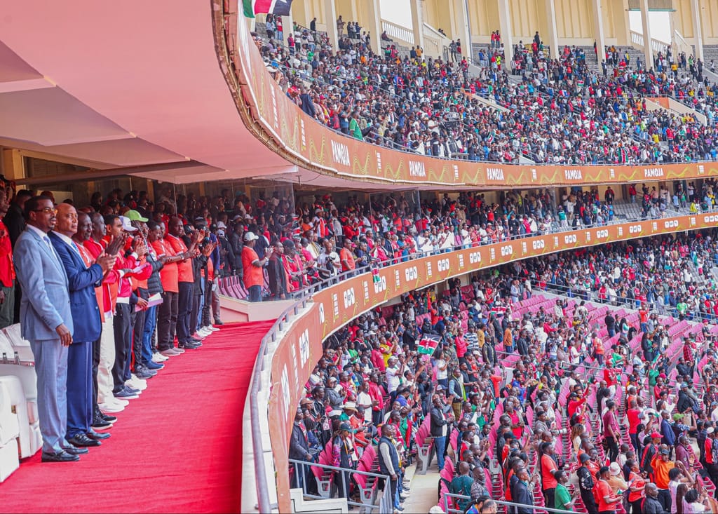 President Ruto and Raila Odinga and Billionaire CAF President Patrice Motsepe leads the fans in giving the Harambee Stars a standing ovation after winning the game against DR Congo at Kasarani Stadium
