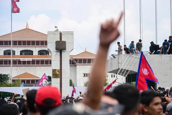 Gen Z protesters gather on the roof and in front of the parliament house as clashes erupt with police at the Federal Parliament in Kathmandu, Nepal, on September 8, 2025. Prakash Shrestha/NurPhoto/Getty Images