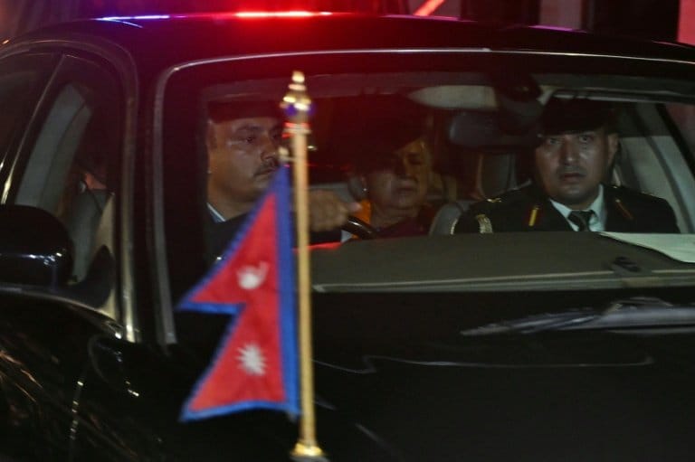 Nepal's new Prime Minister Sushila Karki (C) leaves the presidential palace after her swearing-in-ceremony in Kathmandu / AFP