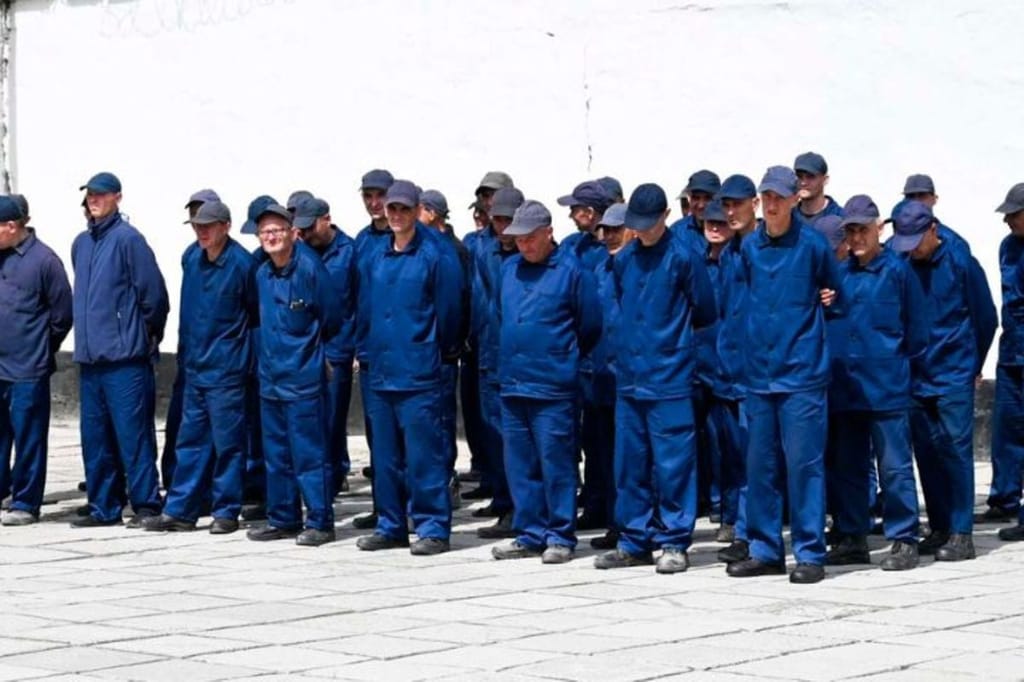 Prisoners of war stand in formation inside a Ukrainian detention facility where foreign fighters are held under strict supervision as part of wartime operations linked to the ongoing Russia-Ukraine conflict.