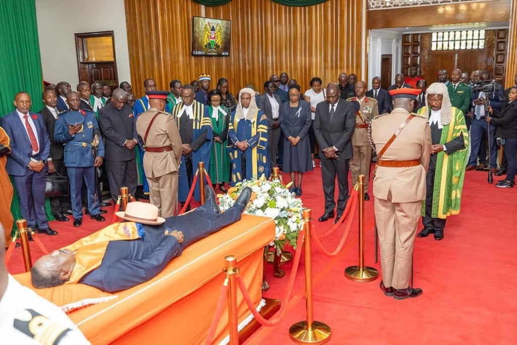 President Ruto pays last respect to Raila Odinga lying in state in parliament building.