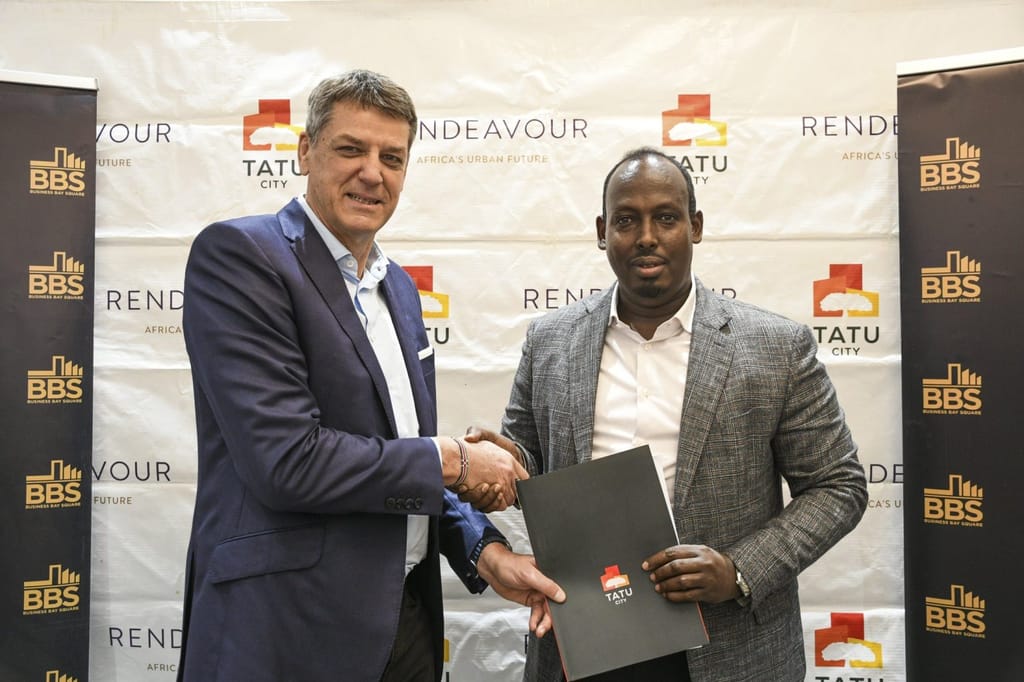 Stephen Jennings, Founder & CEO of Rendeavour, and Abdiweli Hassan, OGW, EBS, Founder & Chairman of Business Bay Square, shake hands after signing a KES 65 billion deal to develop homes, retail, offices, warehousing, and a mosque at Tatu City Special Economic Zone.