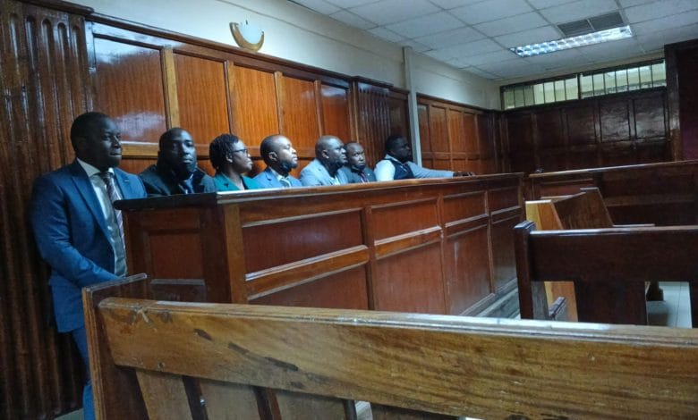 Seven suspects, led by Michael Musyoki Ngumbi, appear at the Milimani Law Courts dock in Nairobi over a Sh60.8 million fake ambulance tender scam, following their arrest at Harambee House, which hosts President William Ruto’s office.