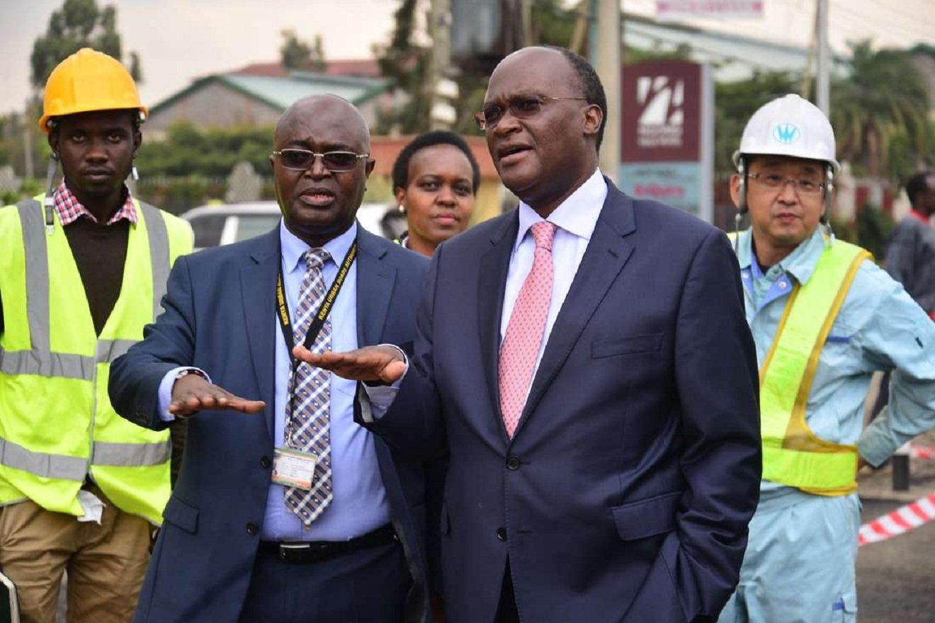 Meet the Junior secretary grabbing CS Macharia by his ankles